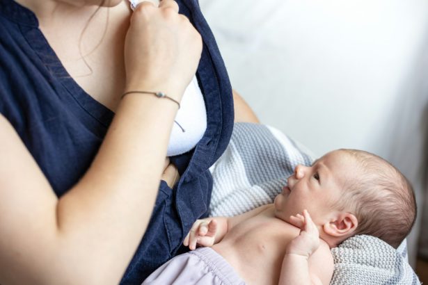 A young mother holds a newborn son in her arms, breastfeeding, lactation.