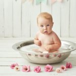 Baby girl wash, infant hygiene, health and skin care. Baby in bath. Children's Day.