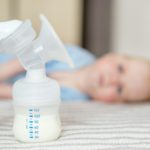 Breast pump with milk. The concept of childhood, motherhood, life style, upbringing.