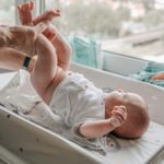 Dad changing baby's diapers