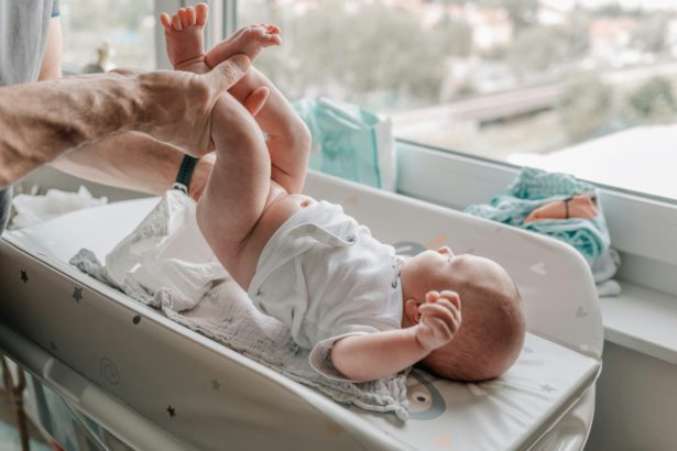 Dad changing baby's diapers