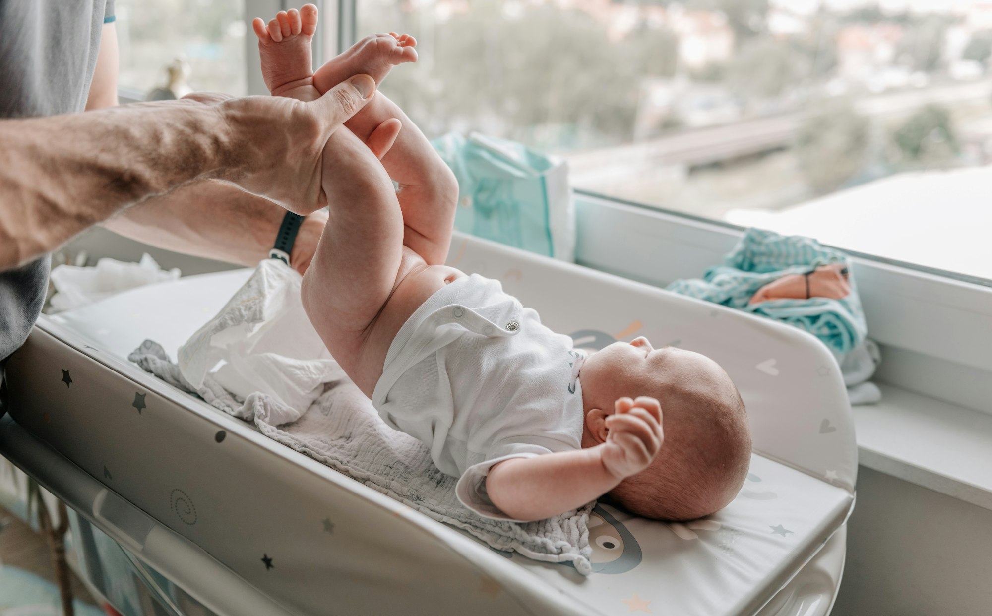 Dad changing baby's diapers