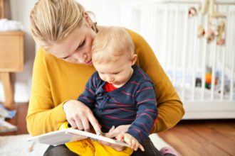 Mother and baby boy reading together