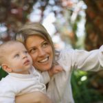 Mother taking picture with baby outdoors