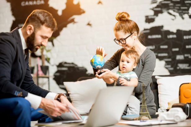 Woman and baby boy with travel agent at the office